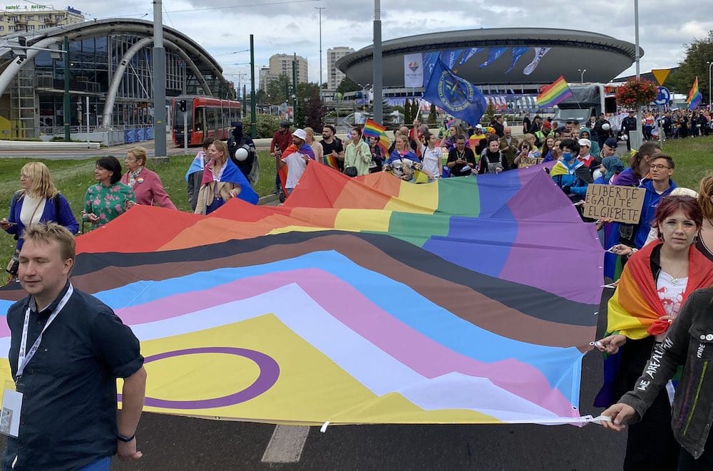 Pride-goers carry a giant Pride flag in Katowice, Poland