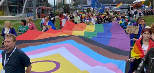 Pride-goers carry a giant Pride flag in Katowice, Poland