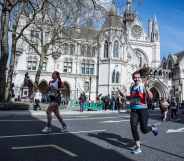 Participants run past The Royal Courts of Justice during the London Landmarks Half Marathon through Westminster and the City.