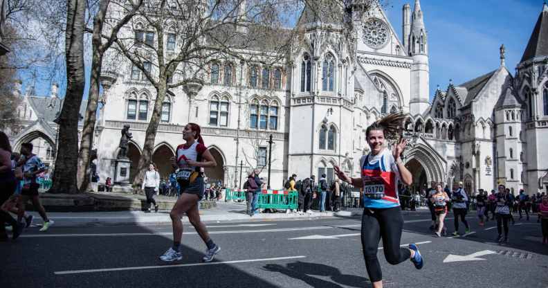 Participants run past The Royal Courts of Justice during the London Landmarks Half Marathon through Westminster and the City.
