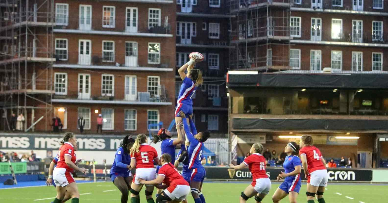 Female rugby in the air catching the ball