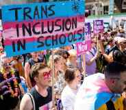 pro-LGBTQ+ protestors marching for trans inclusion in schools.