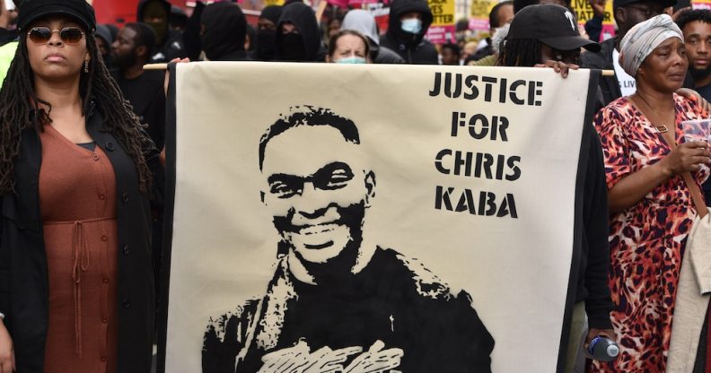 Protesters hold a banner that reads "justice for Chris Kaba" during a march in London