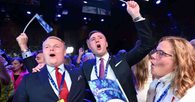 Groups of supporters cheering and waving flags