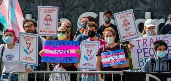 A group of LGBTQ+ activists hold banners promoting trans rights at Boston Children's Hospital where a bomb threat was made a few weeks ago