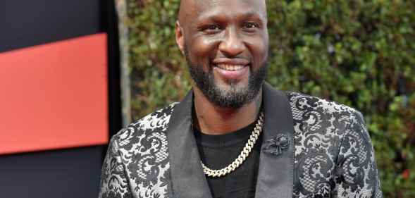 Lamar Odom in a suit smiling