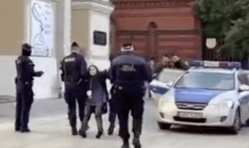 A screenshot from video showing Polish teenager Malwina Chmara being dragged by police in Poland