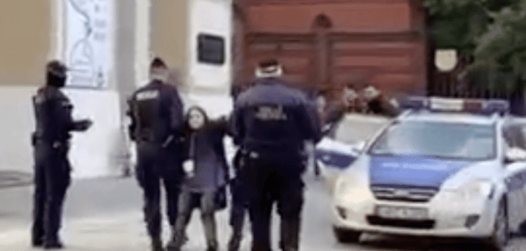 A screenshot from video showing Polish teenager Malwina Chmara being dragged by police in Poland