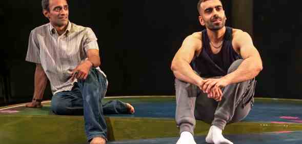 Zafar and Bilal sitting on a sparse stage