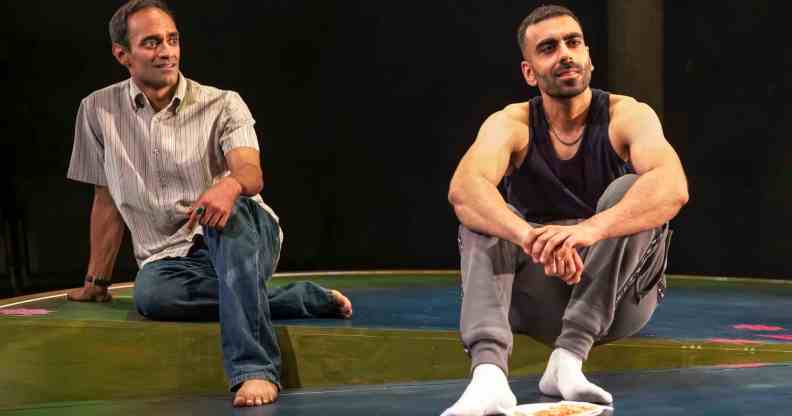 Zafar and Bilal sitting on a sparse stage