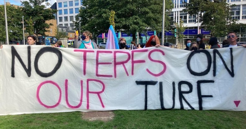 Pro-trans protestors hold a banner reading no terfs on our turf