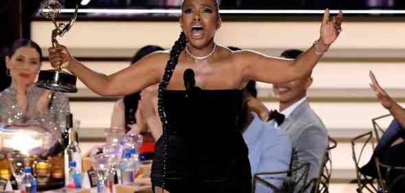 Sheryl Lee Ralph singing while holding her Emmy on stage