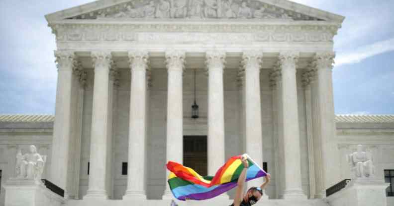 Joseph Fons holding a Pride Flag, walks back and forth in front of the U.S. Supreme Court