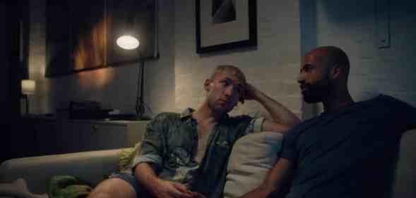 A still from the short film Outdoors with actors Sam Goodchild and Nathan Ives-Moiba sitting on a sofa