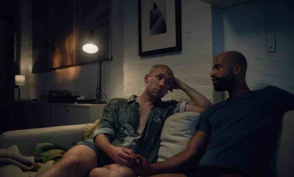 A still from the short film Outdoors with actors Sam Goodchild and Nathan Ives-Moiba sitting on a sofa