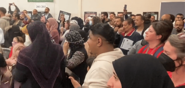 An image from Twitter shows protestors in the Dearborn School Board Meeting