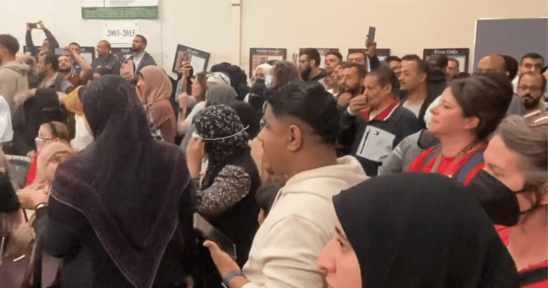 An image from Twitter shows protestors in the Dearborn School Board Meeting