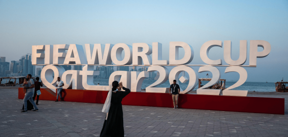 Visitors take photos with a FIFA World Cup sign in Doha, Qatar