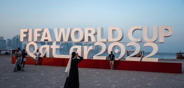 Visitors take photos with a FIFA World Cup sign in Doha, Qatar