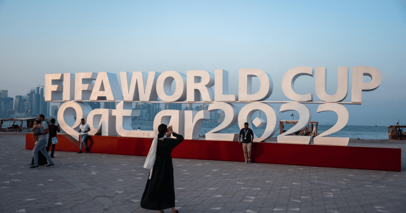 Visitors take photos with a FIFA World Cup sign in Doha, Qatar
