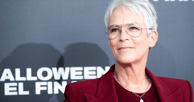 Jamie Lee Curtis wears a red outfit at a press event