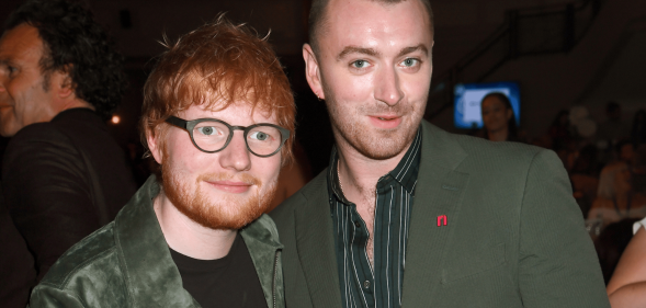 Ed Sheeran and Sam Smith smile and stand next to each other