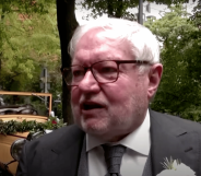 Gay former monk Anselm Bilgri wears a suit as he talks to someone off camera after his wedding