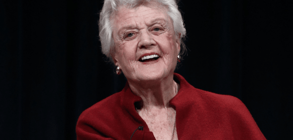 Angela Lansbury wears red as she smiles for the camera