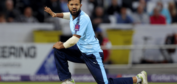 Azeem Rafiq wears a blue uniform as he plays cricket for Yorkshire