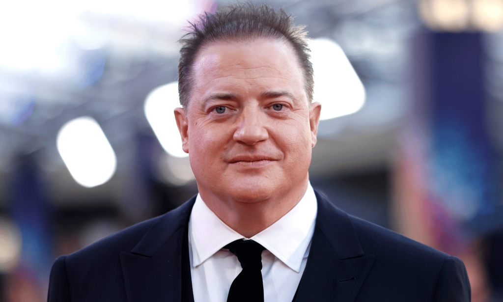 Brendan Fraser wears a suit and tie at an event for The Whale