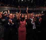 People stand and applaud during a speech at the Conservative Party conference