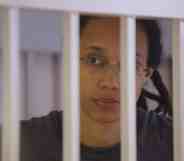 Brittney Griner waits for the verdict inside a defendants' cage during a hearing in Khimki outside Moscow.