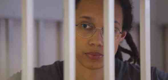 Brittney Griner waits for the verdict inside a defendants' cage during a hearing in Khimki outside Moscow.