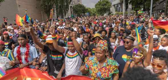 People walk in the streets during the Johannesburg Pride Parade on October 29, 2022 in Johannesburg.