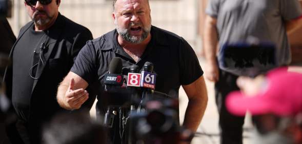 Alex Jones speaks to the media outside Waterbury Superior Court during the defamation trial in Connecticut