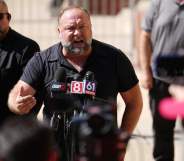 Alex Jones speaks to the media outside Waterbury Superior Court during the defamation trial in Connecticut