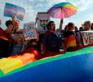 People wave Pride flags during the gay pride rally in Saint Petersburg
