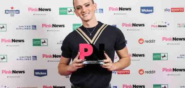 Matt Bernstein smiles with his award at the PinkNews Awards 2022 event. (PinkNews)