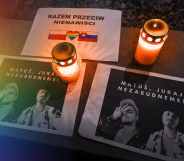 Photos are placed next to candles to honour the gay men killed by a terrorist in Slovakia