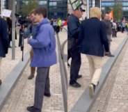 A protester approaching Michael Fabricant as he makes his way into the Conservative Party's conference in Birmingham.