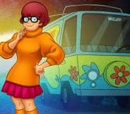 Scooby Doo character Velma stands in front of the Mystery Machine Van. (Warner Bros)