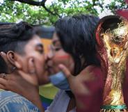 Two people kissing with the World Cup superimposed