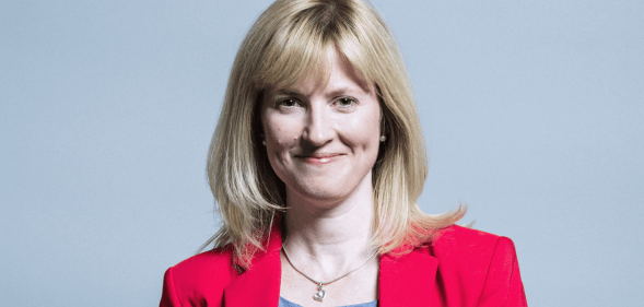 A photo of MP Rosie Duffield wearing a red suit jacket over a grey top