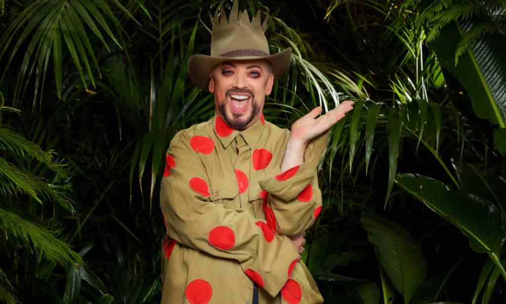 A promo photo of Boy George dressed in his jungle uniform and standing in front of some tropical ferns for the ITV show I'm a Celebrity...Get Me Out of Here! (ITV)