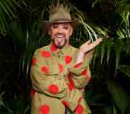 A promo photo of Boy George dressed in his jungle uniform and standing in front of some tropical ferns for the ITV show I'm a Celebrity...Get Me Out of Here! (ITV)