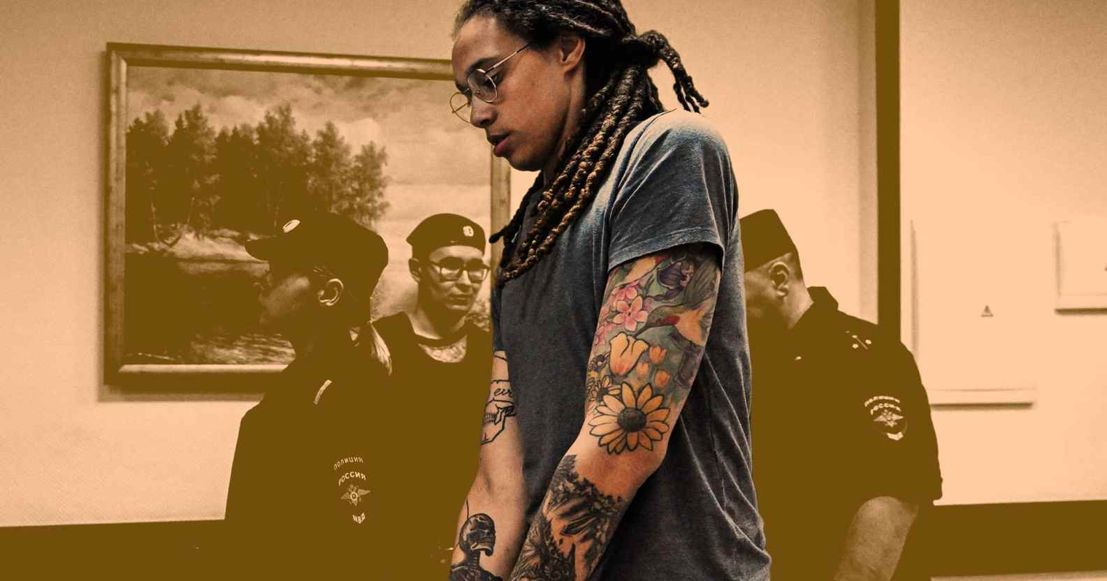 Basketball star Brittney Griner is shown handcuffed against a sepia-toned background with Russian guards behind her