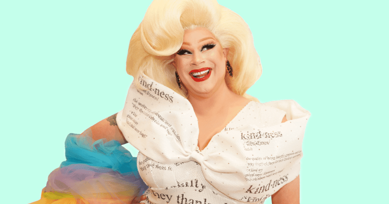 Drag Race queen Nina West wears a white dress with type on it and with rainbow coloured details