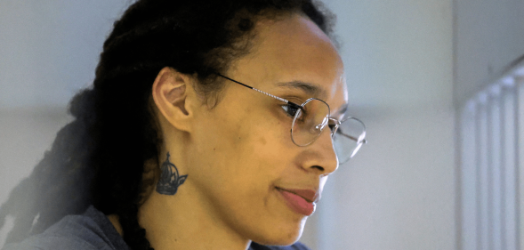 US basketball player Brittney Griner stands in a defendants' cage before a court hearing during her trial on charges of drug smuggling in Russia