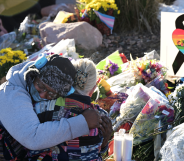 A person gets comforted by a friend at a makeshift memorial near Club Q on November 20, 2022 in Colorado Springs, Colorado. The venue was the scene of a mass shooting