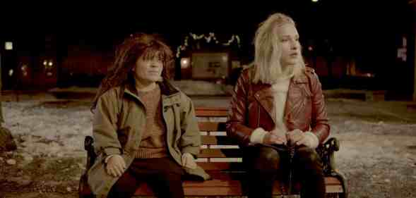 A still from the Norwegian short film Night Ride showing actors Sigrid Husjord and Ola Hoemsnes Sandum who play Ebba and Ariel sitting on a bench at night